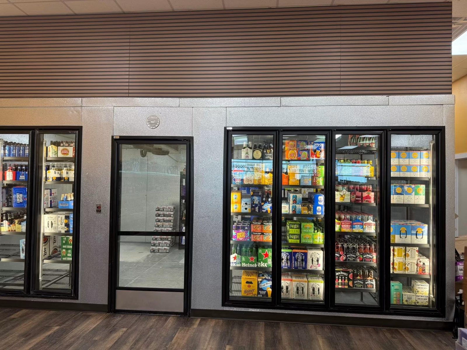 Walk-in beer cooler with craft beer and seltzer at a San Antonio liquor store